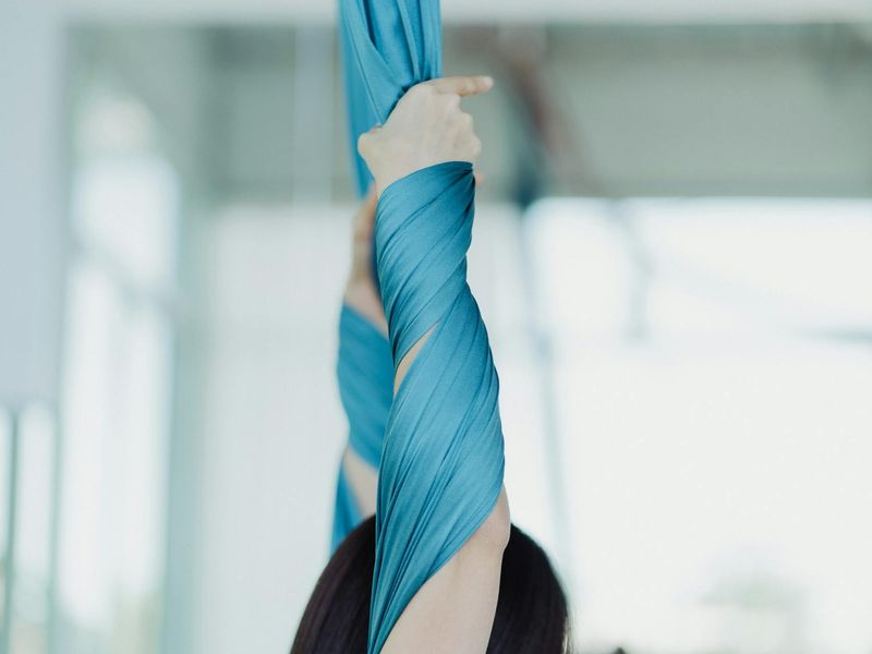 Close-up of hands performing a controlled yoga movement.