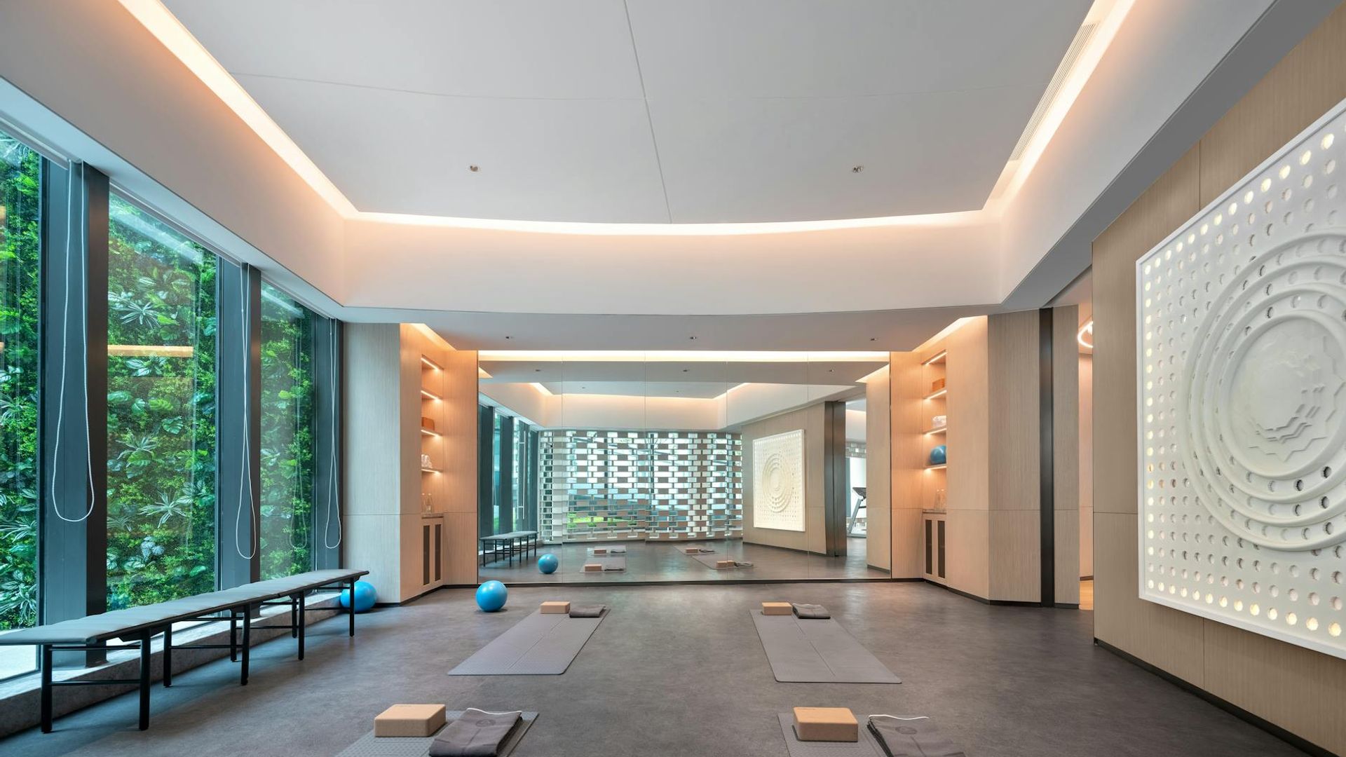 Spacious minimalist yoga studio with soft morning light.